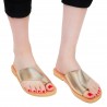 Women's handmade flat thong sandals in gold laminated calf leather
